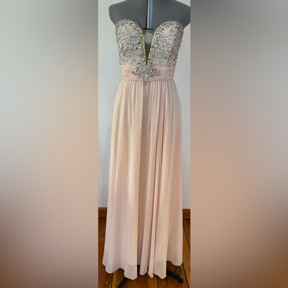 Sleeveless beaded gown with sweetheart neckline and a cutout detail on bust.